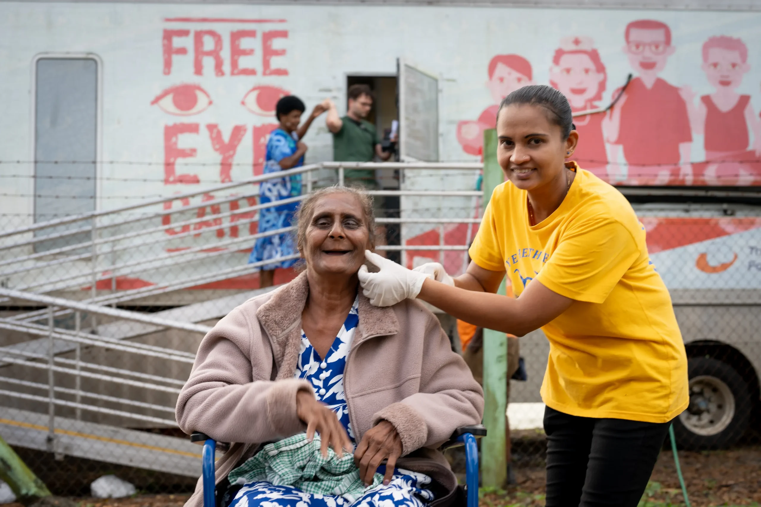 A nurse removing an eye patch from a patient after cataract surgery