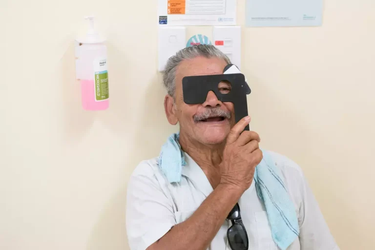 Sione having his eyes tested