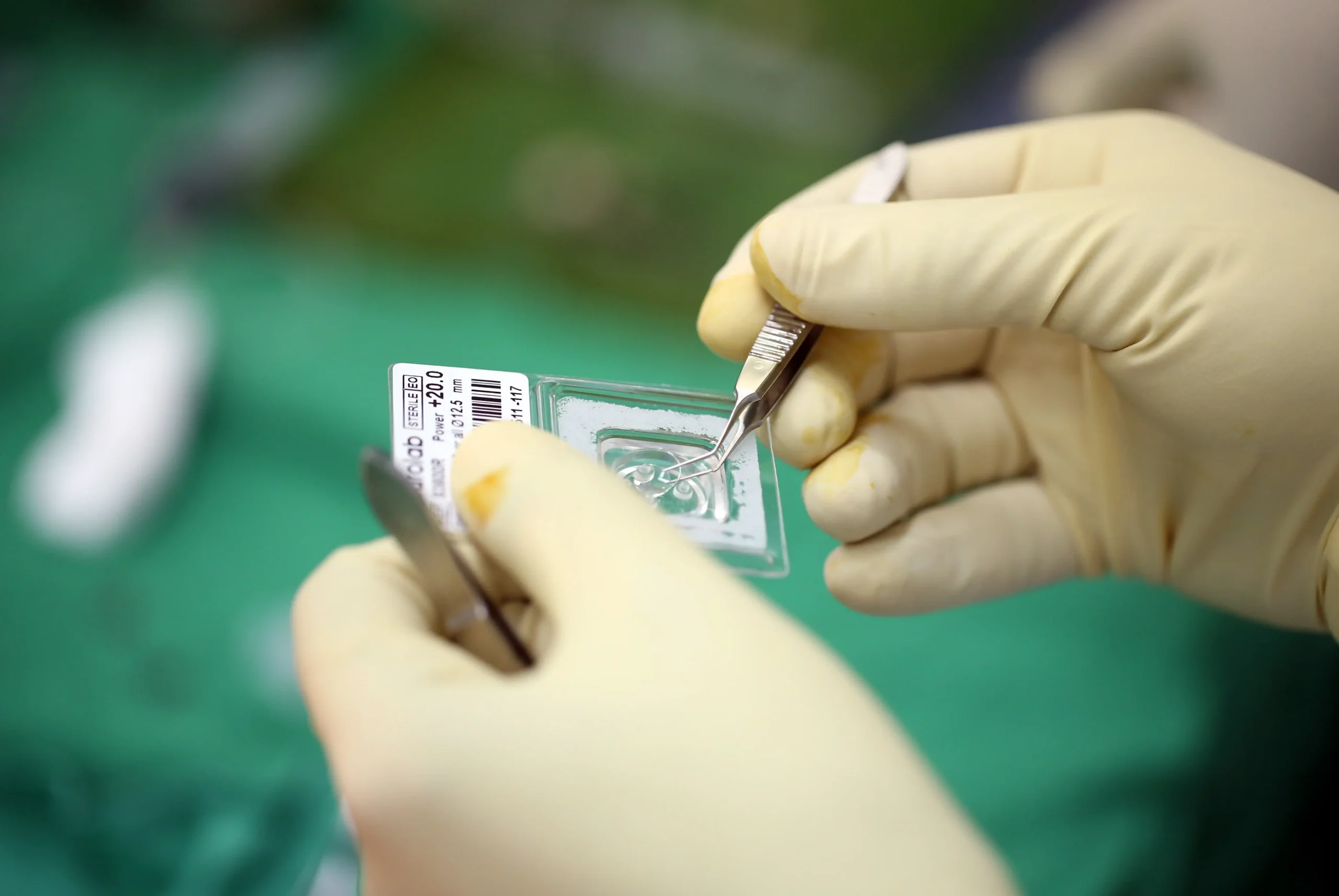 A eye surgeon removing an IOL from its packaging