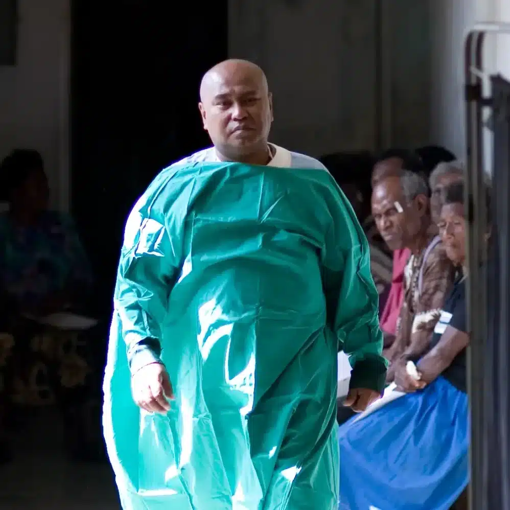 Dr John Szetu in a surgical gown at an outreach