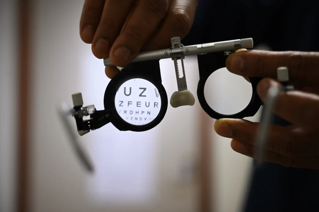 A view of an snellen eye chart through a pair of refractive error lens test glasses
