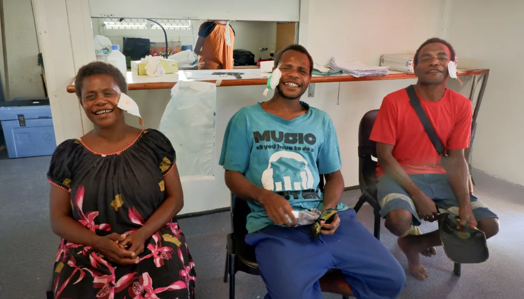 Three siblings with their eye bandages removed