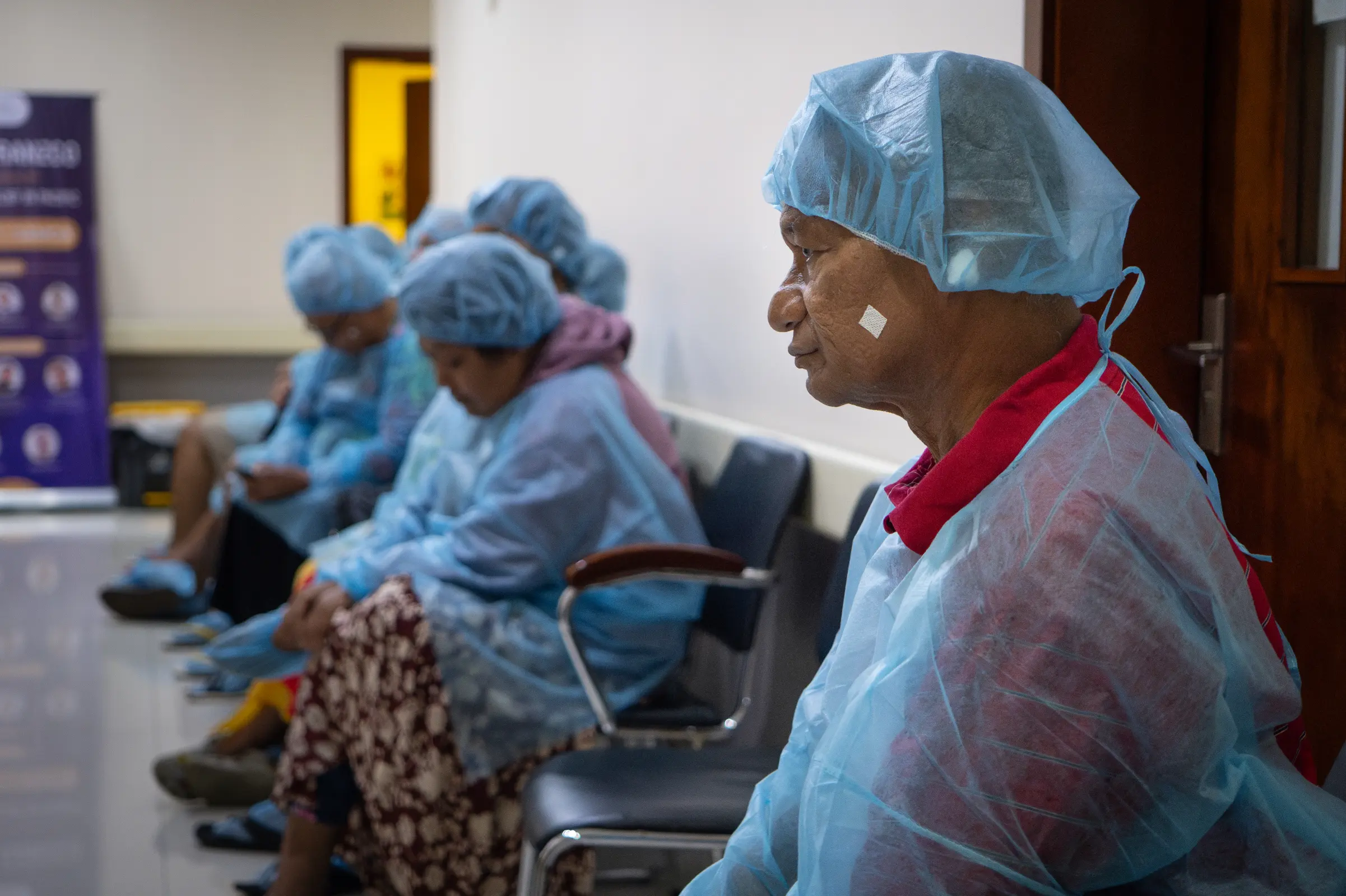 Pateki in the waiting room, dressed for cataract surgery