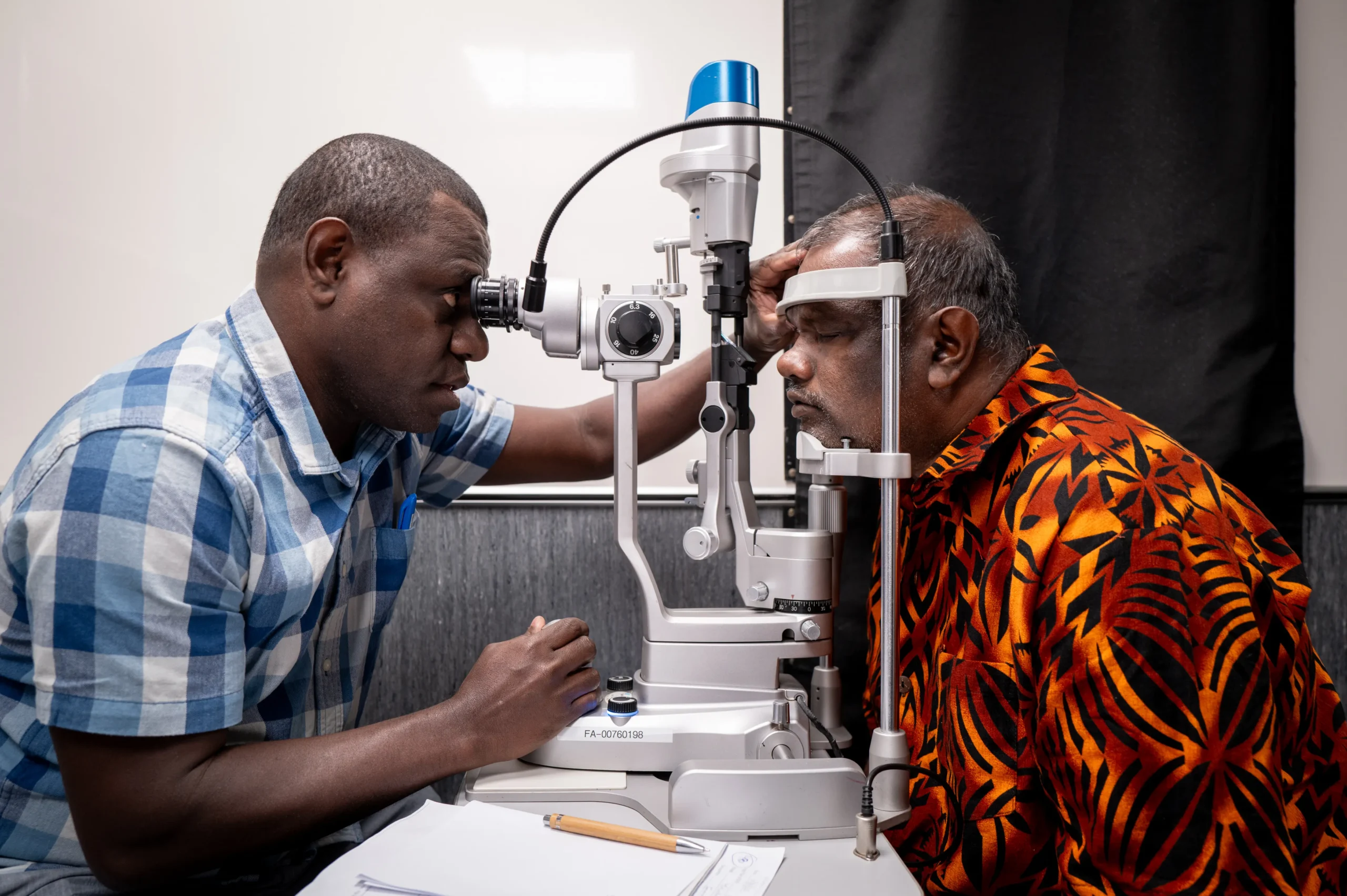 Dr Kalbule examining a patients eyes