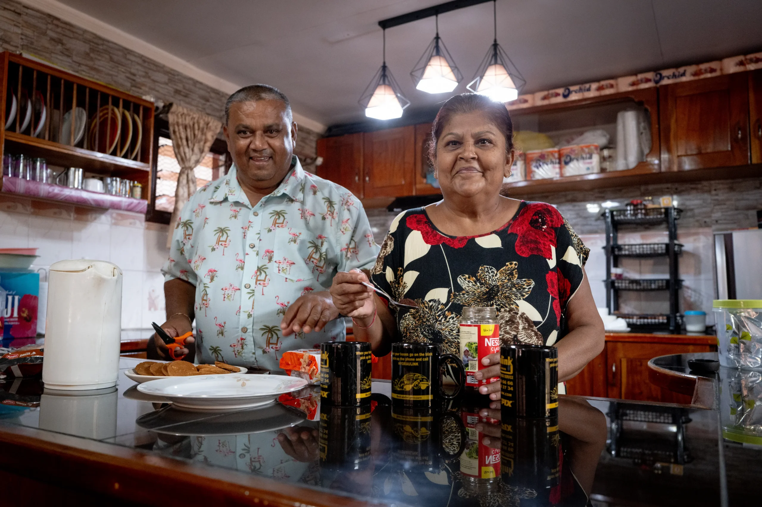 Mahen and Utra making a cup of tea in the kitchen