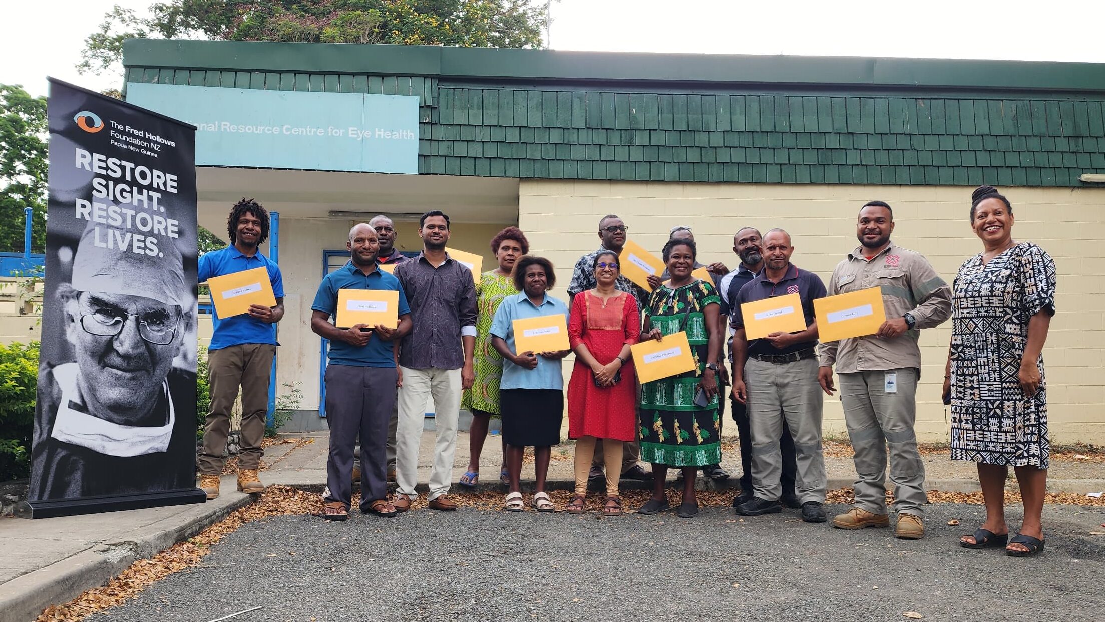 The group gathered outside with their certificates of participation 